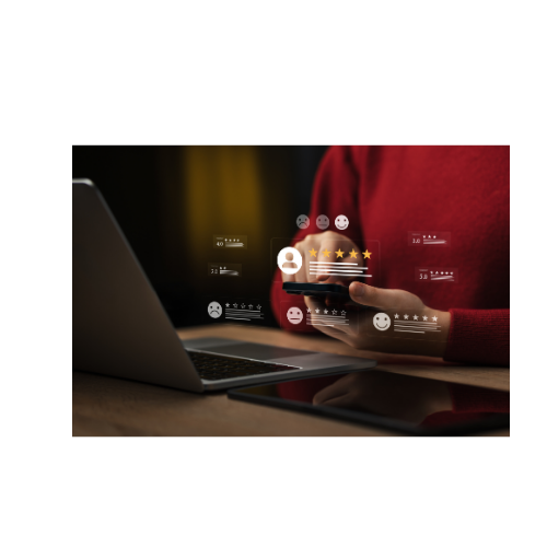 Customer checking review feedback on a phone beside a laptop